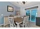 Elegant dining room with stylish furniture, decorative accents, and sliding glass doors to the outdoors at 9 Logan St, Port Charlotte, FL 33954