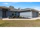 Charming exterior elevation with well-maintained lawn and landscaping at 9 Logan St, Port Charlotte, FL 33954