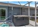 Backyard patio featuring a hot tub with metal safety rails and easy access to home at 9 Logan St, Port Charlotte, FL 33954