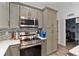Modern kitchen features stainless steel appliances, gray cabinetry, and stylish backsplash at 9 Logan St, Port Charlotte, FL 33954