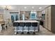 Modern kitchen with a large island, stainless steel appliances, and elegant gray cabinetry, perfect for cooking at 9 Logan St, Port Charlotte, FL 33954