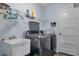 Well-lit laundry room with modern washer/dryer and ample storage space at 9 Logan St, Port Charlotte, FL 33954