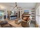 Inviting living room with a stone fireplace and a seamless flow to the kitchen and dining area at 9 Logan St, Port Charlotte, FL 33954