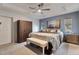 Well-lit main bedroom featuring a ceiling fan, closet, and neutral-toned walls and decor at 9 Logan St, Port Charlotte, FL 33954