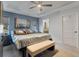 Bright main bedroom with tray ceiling, large bed, bench, and serene wall art at 9 Logan St, Port Charlotte, FL 33954