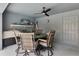Enclosed lanai features an outdoor dining area with ceiling fan and outdoor television for entertainment at 9 Logan St, Port Charlotte, FL 33954