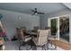 Covered patio features an outdoor dining area with ceiling fan and sliding door access to the home at 9 Logan St, Port Charlotte, FL 33954