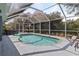 Screened pool boasts an inviting pool with deck area, perfect for relaxation and outdoor enjoyment at 9 Logan St, Port Charlotte, FL 33954