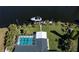 Aerial view of a screened in pool and private dock on canal with boat at 125 Ott Cir, Port Charlotte, FL 33952