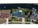Aerial view of a home with pool and private dock on canal with boat at 125 Ott Cir, Port Charlotte, FL 33952