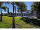 Expansive backyard featuring a screened in pool and lush green lawn at 125 Ott Cir, Port Charlotte, FL 33952