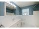 Bathroom featuring vanity, mirror with lights, and white tiled walls at 125 Ott Cir, Port Charlotte, FL 33952