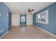 Blue bedroom with tile flooring, ceiling fan, and built in storage cabinets at 125 Ott Cir, Port Charlotte, FL 33952