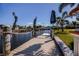 View of the wooden dock, adorned with nautical decorations, leading to the serene waterfront canal at 125 Ott Cir, Port Charlotte, FL 33952