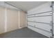 Empty two car garage area with paint spots on wall and a clean gray concrete flooring at 125 Ott Cir, Port Charlotte, FL 33952