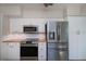 Kitchen area featuring stainless steel appliances, white cabinets, and wood countertops at 125 Ott Cir, Port Charlotte, FL 33952