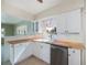 Kitchen area featuring stainless steel appliances, white cabinets, and wood countertops at 125 Ott Cir, Port Charlotte, FL 33952