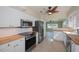 Kitchen with stainless steel appliances, white cabinets, and wood countertops at 125 Ott Cir, Port Charlotte, FL 33952