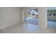 Bright interior with tile floors and screened in pool views through the glass doors at 125 Ott Cir, Port Charlotte, FL 33952