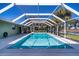Backyard pool featuring white concrete pool deck and beautiful landscaping at 125 Ott Cir, Port Charlotte, FL 33952