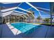 Screened-in pool overlooking a waterway, surrounded by palm trees at 125 Ott Cir, Port Charlotte, FL 33952