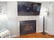 Living room fireplace featuring decorative mantel and hearth, with entertainment center above at 1311 Abscott St, Port Charlotte, FL 33952
