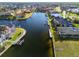 Aerial view of a waterfront home with a private dock along a canal in a residential neighborhood at 3415 Tripoli Blvd, Punta Gorda, FL 33950