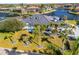 Aerial view of a single-story home with a beautiful yard, tropical landscaping, and waterfront access at 3415 Tripoli Blvd, Punta Gorda, FL 33950