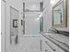 Modern bathroom showcasing a glass-enclosed shower over tub, a sleek vanity, and a luxurious spa-like design at 3415 Tripoli Blvd, Punta Gorda, FL 33950