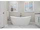 Bright bathroom showcasing a freestanding tub with modern fixtures and shuttered windows, perfect for a relaxing and spa-like experience at 3415 Tripoli Blvd, Punta Gorda, FL 33950