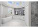 Luxurious bathroom with a soaking tub, dual vanities, and a sleek, modern design at 3415 Tripoli Blvd, Punta Gorda, FL 33950