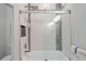 Contemporary bathroom featuring a modern shower-tub, neutral tones, and a glass door for a clean, bright and functional design at 3415 Tripoli Blvd, Punta Gorda, FL 33950