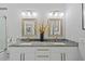 Bathroom featuring dual sinks, granite countertops, and modern fixtures, perfect for a functional and stylish space at 3415 Tripoli Blvd, Punta Gorda, FL 33950