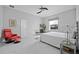 Spacious bedroom with white marble floors, a ceiling fan, and a large window, complemented by stylish decor and furniture at 3415 Tripoli Blvd, Punta Gorda, FL 33950
