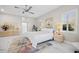 Well-lit bedroom featuring an exercise machine, a ceiling fan, and views from two windows at 3415 Tripoli Blvd, Punta Gorda, FL 33950