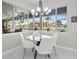 Bright dining area with waterfront views, a modern chandelier, and a glass table at 3415 Tripoli Blvd, Punta Gorda, FL 33950