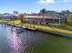 Waterfront home with a screened lanai, spacious backyard, and private dock along the canal at 3415 Tripoli Blvd, Punta Gorda, FL 33950