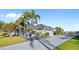 Well-maintained single-story home boasting a paved driveway, tropical landscaping, and attached garage at 3415 Tripoli Blvd, Punta Gorda, FL 33950