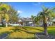 Charming single-story home featuring a lush lawn, mature trees, and a welcoming front porch at 3415 Tripoli Blvd, Punta Gorda, FL 33950