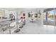 Modern kitchen with island seating, white cabinetry, and views into the Gathering room and outdoor pool area at 3415 Tripoli Blvd, Punta Gorda, FL 33950