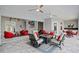 Large, covered outdoor living space with comfortable seating and a ceiling fan at 3415 Tripoli Blvd, Punta Gorda, FL 33950