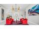 Bright living room with high ceilings, modern art, and comfortable red seating around a glass coffee table at 3415 Tripoli Blvd, Punta Gorda, FL 33950