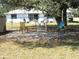 Backyard patio with seating area, lush greenery, and a view of the home at 1247 Petronia St, North Port, FL 34286