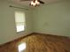 Bedroom with hardwood floors, a window, and ceiling fan at 1247 Petronia St, North Port, FL 34286