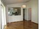 Dining area with hardwood floors and a view of the kitchen through a decorative mirror at 1247 Petronia St, North Port, FL 34286