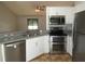 Bright kitchen features stainless steel appliances, white cabinets, and stylish countertops and backsplash at 1247 Petronia St, North Port, FL 34286