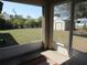 View from screened in porch to the backyard with lush greenery and detached shed at 1247 Petronia St, North Port, FL 34286