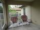 Inviting screened in porch with comfortable wicker chairs and a view of the surrounding yard at 1247 Petronia St, North Port, FL 34286