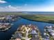 An aerial view of a waterfront home surrounded by lush foliage and sparkling blue water at 1339 Casey Key Dr, Punta Gorda, FL 33950