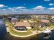 Aerial view of waterfront homes with lush landscaping and private docks on a sunny day at 1339 Casey Key Dr, Punta Gorda, FL 33950
